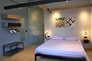 a bedroom with a large bed and a piano at INVENTO bnb unconventional maison in Civitanova Marche