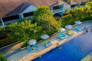an overhead view of a swimming pool with chairs and umbrellas at Montigo Resorts Seminyak in Seminyak
