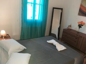 a bedroom with a bed with two towels on it at Nikolettas Apartments in Faros