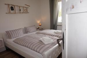 a white bed with two pillows on it in a bedroom at Ferienhaus Hundertmorgenfeld 33 in Wernigerode