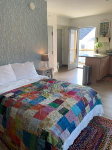 a bedroom with a colorful quilt on a bed at Black Elephant Hostel in Portland