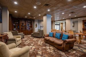 a lobby with couches and chairs and a table at Lodge of the Ozarks in Branson