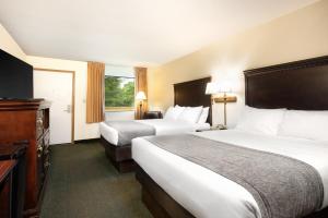 a hotel room with two beds and a television at Brookwood Inn Branson in Branson +22 photos
