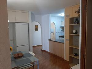 a kitchen with a white refrigerator and a table at Paraiso in Tacoronte