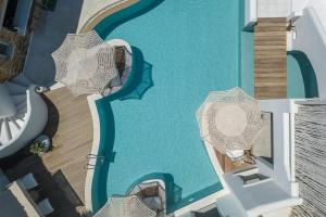 an overhead view of a swimming pool with umbrellas at Virtu Suites in Agios Prokopios