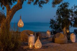 a group of lights on the beach at night at Virtu Suites in Agios Prokopios