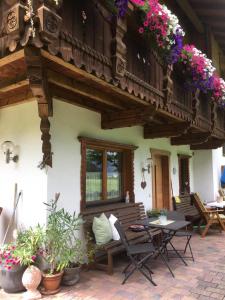a house with a bench and a balcony with flowers at Haus Marco in Neustift im Stubaital