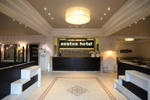 a lobby of a nostos hotel with a bar at Nostos Hotel in Afitos