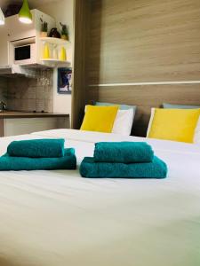 Una cama blanca con almohadas azules. en Art Studio, en Chamonix-Mont-Blanc