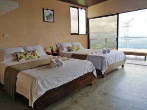 מיטה או מיטות בחדר ב-Casa Linda Vista
