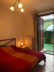 a bedroom with a bed and a sliding glass door at Costa Verde Apartment in Predore