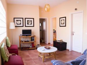 a living room with a couch and a table at Los Olivos in Playa de Santiago