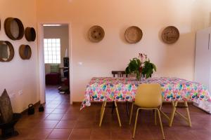 a dining room with a table and chairs at Los Olivos in Playa de Santiago