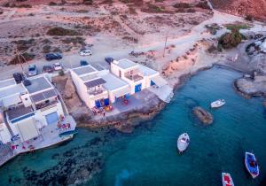 an aerial view of a house with a boat in the water at Beach Suite Syrma in Pachaina