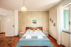 a bedroom with a bed with two tables and a window at Villa Antonella in Sorrento