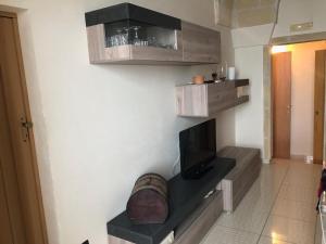 a living room with a tv on a wall at Casa al mare in Torre Canne
