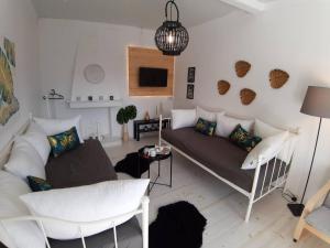 a living room with a couch and a tv at Summer House Moschovi in Skala Potamias