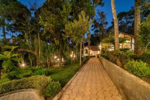 a walkway in front of a house at night at Pousada Jardim da Mantiqueira in Monte Verde