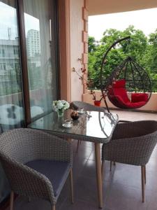 a table and chairs in a room with a window at Apartment MaxinJauri in Makhinjauri