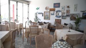 a restaurant with tables and chairs in a room at Hotel Isolabella in Ventotene