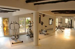 a gym with treadmills and exercise bikes in a room at Jacaranda Beach Resort in Watamu