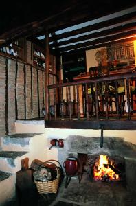 a stone fireplace with pots and pans in a room at Posada la Trebede in Perrozo
