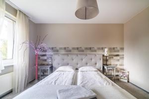 Postel nebo postele na pokoji v ubytování Willa Onyks Apartamenty