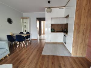 a kitchen and living room with a table and chairs at 2K Best Apartment in Katowice
