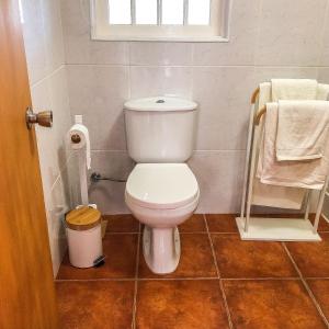 a small bathroom with a toilet and a window at eSense - Formosinha in Madalena +10 photos