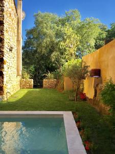 a swimming pool in the yard of a house at XIXe Provencal Stone House with Private Pool near Uzes in Uzès