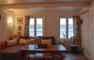 a living room with a couch and a table at Amazing Home In Staubø With Wifi in Staubø