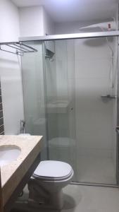 a bathroom with a toilet and a glass shower at Park Veredas in Rio Quente +15 photos