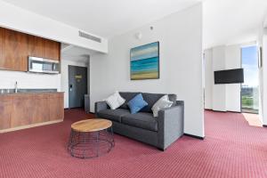 a living room with a couch and a table at The Parc Hotel in Queens