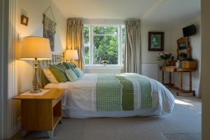 a bedroom with a bed and a window at Theatre Royal Hotel in Kumara