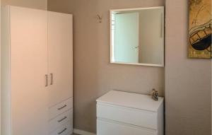 a bathroom with a white cabinet and a mirror at Appartement 3 - De Eekhof in Hindeloopen