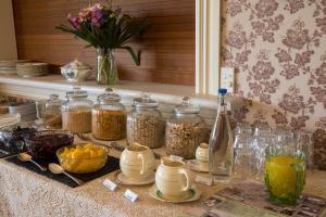 a table with jars of food and other items on it at Theatre Royal Hotel in Kumara +55 photos