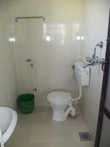 a small bathroom with a toilet and a sink at Seven Steps Guest House in Muglaha