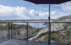 a balcony with an umbrella and a view of the water at Leil 705 in Kragerø