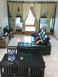 a living room with a couch and a table at PM Octagon Ipoh Duplex Suite (4-12paxs) in Ipoh