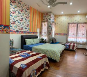 a bedroom with two beds and colorful wallpaper at NEW RETRO@GEORGETOWN #WIFI/Spacious/Comfort/Clean. in George Town