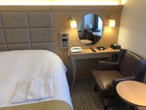 Postel nebo postele na pokoji v ubytování Kobe Luminous Hotel Sannomiya