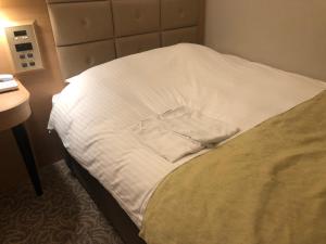 Postel nebo postele na pokoji v ubytování Kobe Luminous Hotel Sannomiya