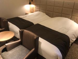 Postel nebo postele na pokoji v ubytování Kobe Luminous Hotel Sannomiya