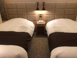 Postel nebo postele na pokoji v ubytování Kobe Luminous Hotel Sannomiya