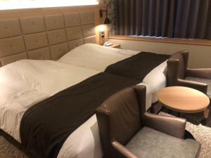 Postel nebo postele na pokoji v ubytování Kobe Luminous Hotel Sannomiya