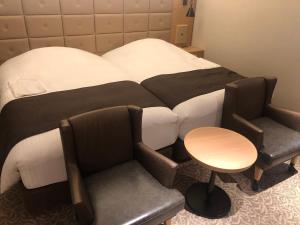 Postel nebo postele na pokoji v ubytování Kobe Luminous Hotel Sannomiya