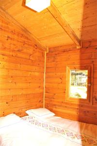 A bed or beds in a room at Camping Abadesses