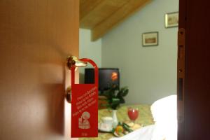 a door with a red sign hanging from it at Il Pioniere in Villafranca di Verona