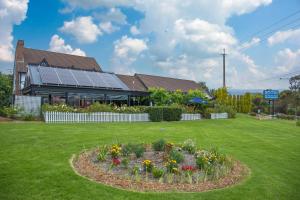 a house with a garden with flowers in front of it at Mick O'Sheas in Hackham