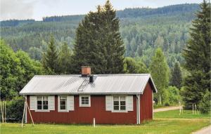 a red and white house in a field with trees at Amazing Home In Sysslebck With Kitchen in Sysslebäck